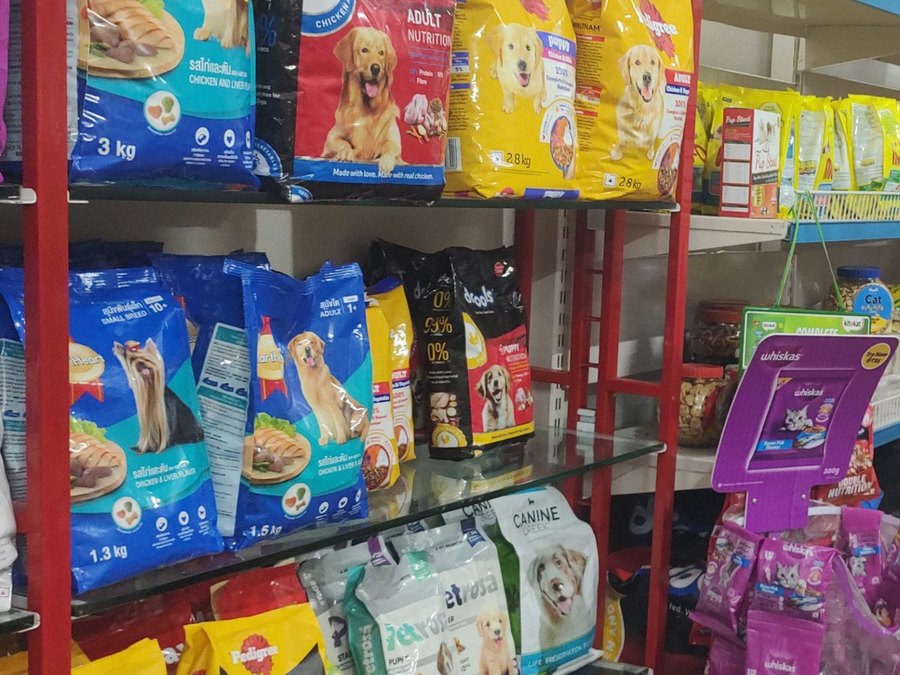 Pedigree, Drools and Royal Canin dog food bags on the shelves at Shree Swami Samarth Pets Shop, Ulhasnagar